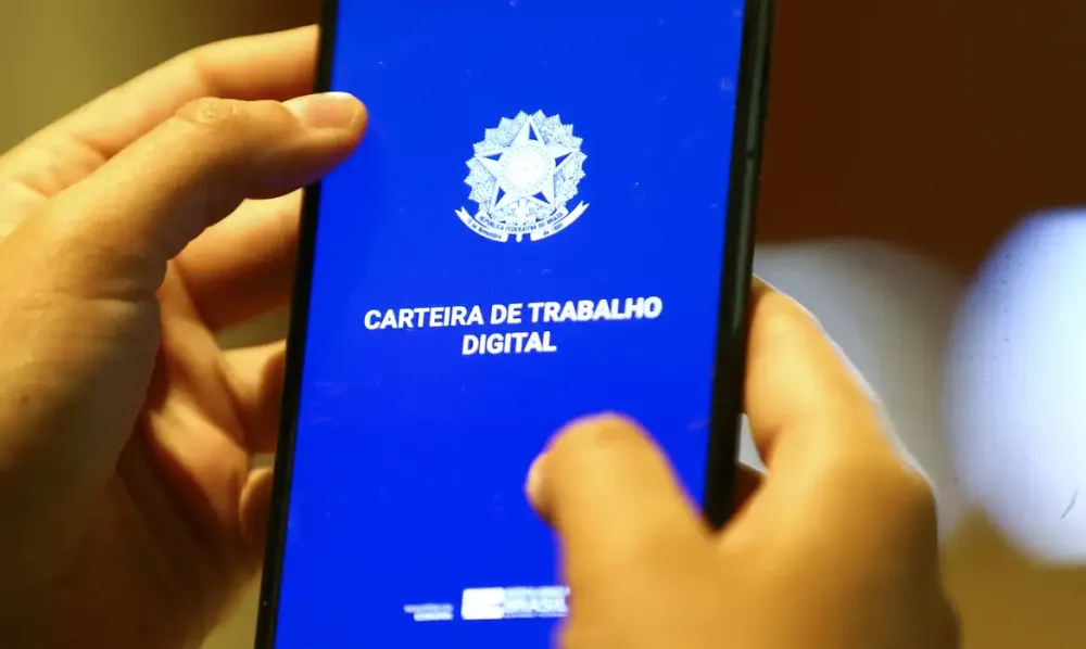 Marcelo Camargo/Agência Brasil, Carteira de Trabalho Digital exibida em celular.